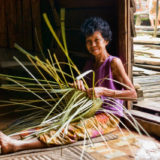 Woman making straw basket