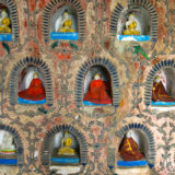 Little Buddha statues in temple wall