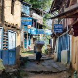 Porter walking in a village