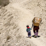 Kid and woman on mountain path