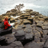 Girl sitting at seashore