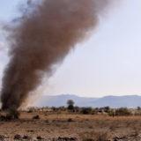 People running for dust devil