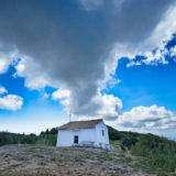 White cabin with clouds